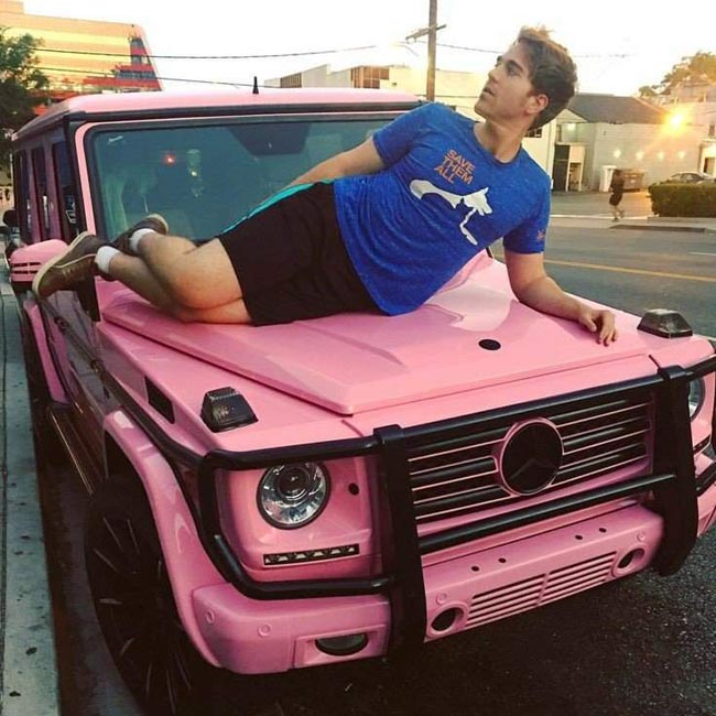 Shane taking a picture with his Mercedes Benz.